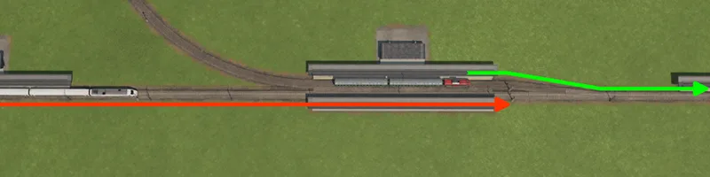 Red and green route arrows through a station and adjoining railway