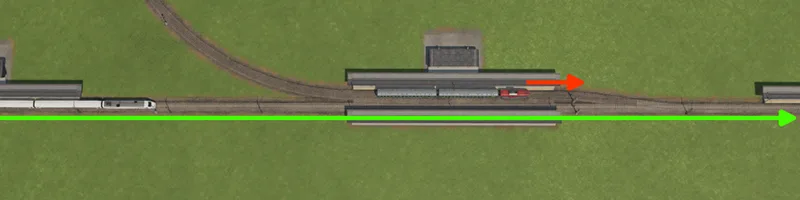 Two trains near a station with red and green route arrows along the railway